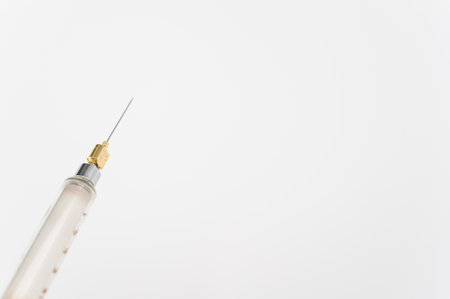 an isolated injection syringe on white paper background with text spaceの写真素材