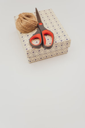 a closed white paperboard decorated box on white background with text space and stationeryの写真素材