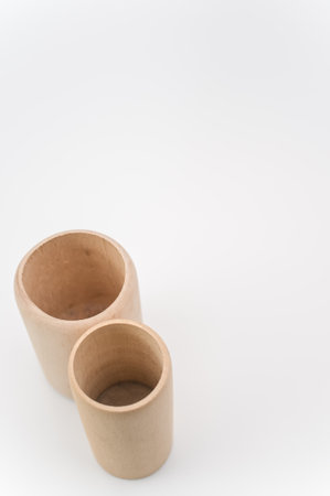 cylindrical pen holder made of solid wood on a white surface with text spaceの写真素材