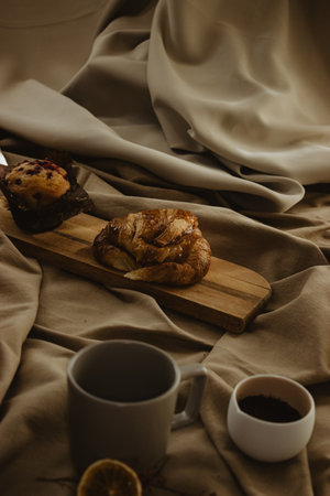 Croissant and cupcake with a mediterranean breakfast in a background beige isolated. Space for...