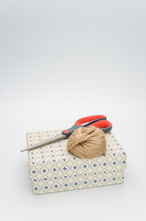 a closed white paperboard decorated box on white background with text space and stationeryの写真素材