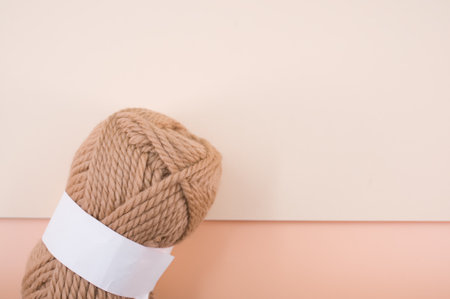 shot of isolated beige yarn on beige background with text spaceの写真素材
