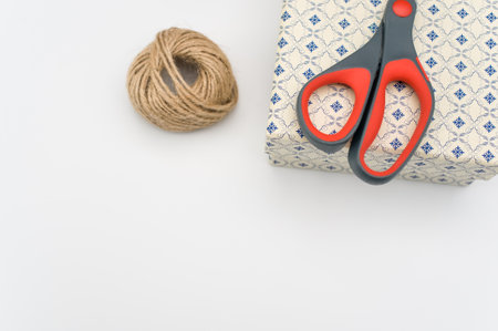 a closed white paperboard decorated box on white background with text space and stationeryの写真素材