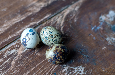 close up of tiny quail eggs on a rustic wood table