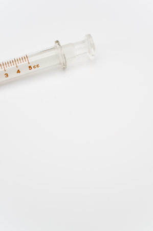 an isolated injection syringe on white paper background with text space