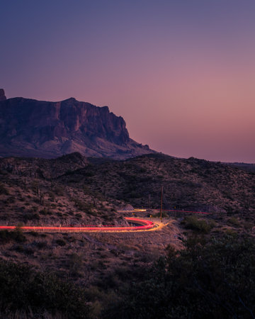Cars wind their way up scenic highway 88 as twilight settles over The Superstition mountains.