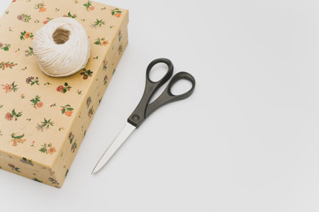 a closed paperboard box with stationery on white background with text spaceの写真素材