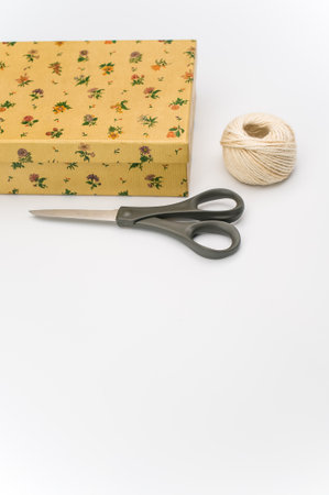 a closed paperboard box with stationery on white background with text spaceの写真素材