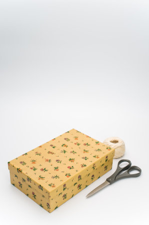 a closed paperboard box with stationery on white background with text spaceの写真素材
