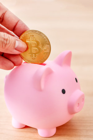 Putting bitcoin to piggy bank, new virtual electronic and digital money, hodl investment concept.の写真素材