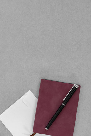 Mockup with empty sketchbook or notebook with black pen on gray background.の写真素材
