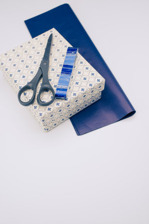 blue paper and decorated box on white background with text space and stationeryの写真素材