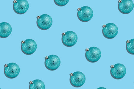 pattern of shiny blue christmas spheres, on a light blue backgroundの写真素材