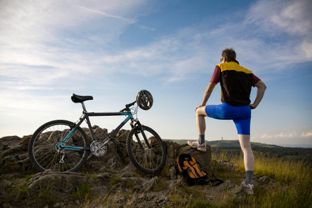 a male cyclist takes a break on the Herzogenhorn in the Black Forestの写真素材
