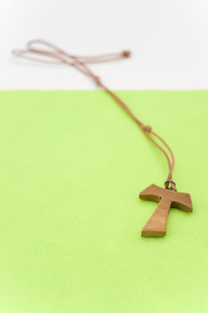isolated hand carved solid wood greek letter tau  pendant with space for textの写真素材