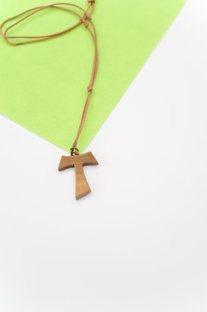 isolated hand carved solid wood greek letter tau  pendant with space for textの写真素材