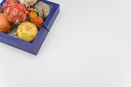 Multicolored Christmas decorative balls and figurines in a blue wooden box with sapce for text
