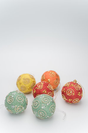 Multicolored Christmas decorative balls with sapce for text on a white surfaceの写真素材