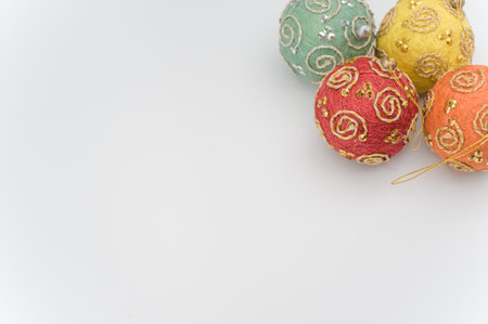Multicolored Christmas decorative balls with sapce for text on a white surfaceの写真素材