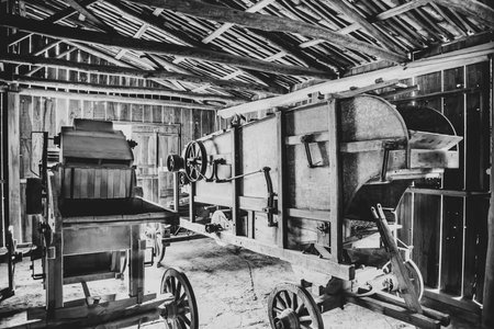 Old farm equipment in black and white photo.の写真素材