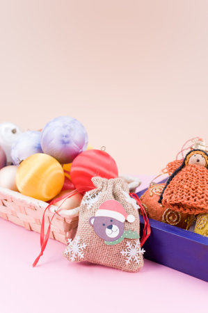 Multicolored Christmas decorative balls and figurines in a blue wooden box with sapce for textの写真素材