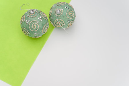 Green Christmas decorative balls with sapce for text on a white green  surface