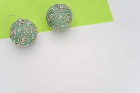 Green Christmas decorative balls with sapce for text on a white green  surfaceの写真素材