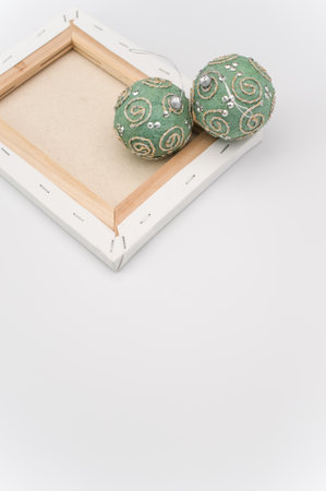 Elegant green silver Christmas decorations and painting canvas with sapce for text on a white...