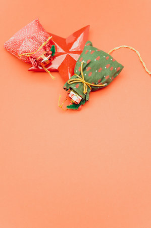 Christmas time decorations with sapce for text on an orange paper surfaceの写真素材