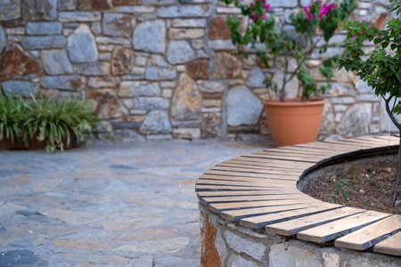 empty wooden floor in front of stone wallの写真素材