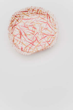 multicolored empty paper baking cups on a white background with text space