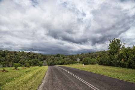 Heavy Clouds over road in Queensland, Australiaの写真素材