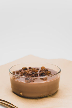 tasty cocoa and chocolate pudding with raisins on top in a bowl with space for textの写真素材