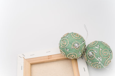 Elegant green silver Christmas decorations and painting canvas with sapce for text on a white...