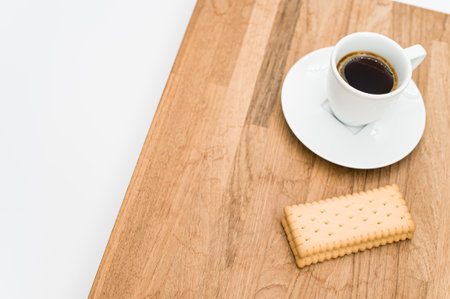 espresso coffee and biscuits on a wooden chopping board and white background with copy spaceの写真素材