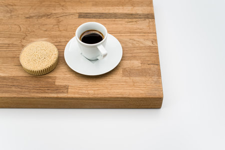 espresso coffee and buckwheat flour organic cake on a wooden and white background with copy space