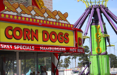 Tyler, TX - September 28, 2011: Corn Dog Sign and Carnival Ride at local street carnivalのeditorial素材