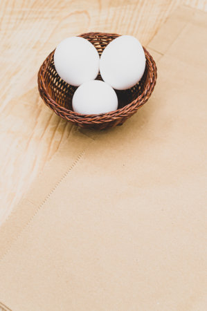 organic white eggs in a canister on a natural wooden and paper background with copy space for textの写真素材
