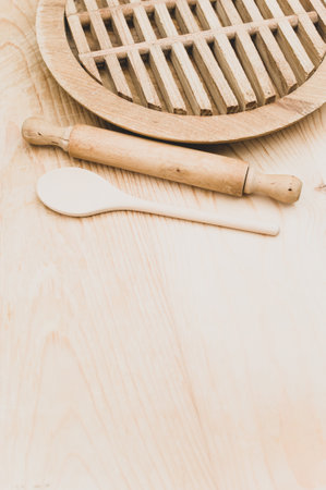 top view of wooden kitchen utensils and chopping board on a wooden background with copy spaceの写真素材