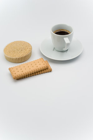 black hot ristretto coffe in a white stoneware cup with plate and pastries on a white surface with text spaceの写真素材