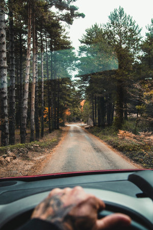 View of car driving on the road of a downhill mountain passの写真素材