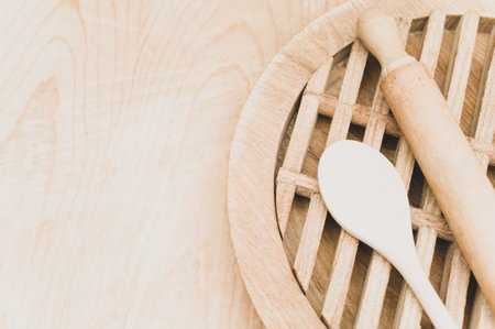 top view of wooden kitchen utensils and chopping board on a wooden background with copy spaceの写真素材