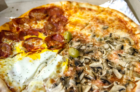 Fresh, just delivered Quattro Stagioni pizza, still in cardboard boxの写真素材