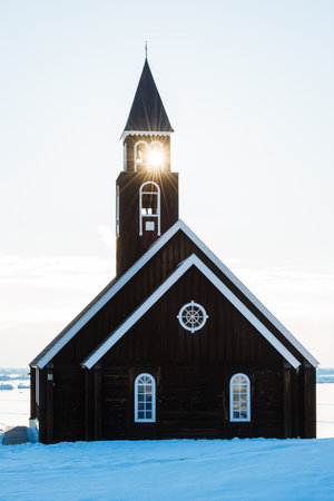 Sunlight through the steeple of a church in winterの写真素材