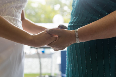 Mother of the bride giving hands to the bride in the morning before the ceremony, photos at the...