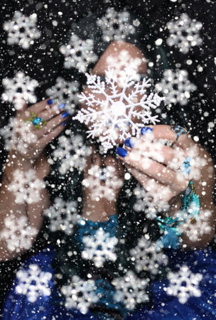 Woman with snowflake ornament and snow stormの写真素材