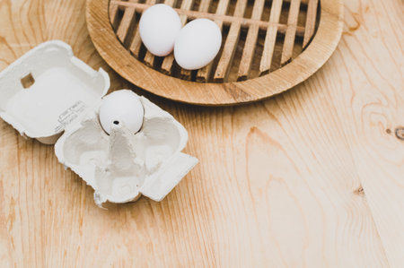 cardboard egg box made of recyclables materials with space for text on a wooden tabletopの写真素材