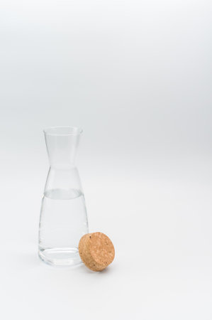 glass flask filled with pure clean water on a white background with text spaceの写真素材