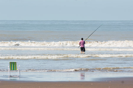 1 men fishing on the beachの写真素材