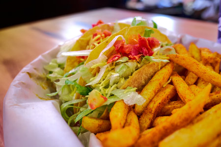 Box set of tasty taco and nachos served in retail background of taco restaurantの写真素材